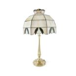 AN ART NOUVEAU CAST BRASS TABLE LAMP, c.1900, with twin light sockets, tapering stem and circular
