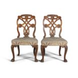 A PAIR OF GEORGE III MAHOGANY FRAMED DINING CHAIRS, with open pierced interlaced backs and carved