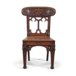 A VICTORIAN MAHOGANY GOTHIC REVIVAL HALL CHAIR, the curved tablet back centered with shield shaped