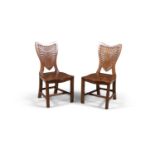 A PAIR OF 19TH CENTURY PALE MAHOGANY SHIELD BACK HALL CHAIRS, the backs with starburst carving,