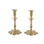 A PAIR OF QUEEN ANNE BRASS CANDLESTICKS, c.1700, each with flared circular nozzles and knopped