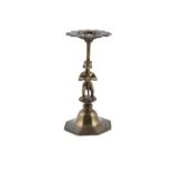 AN INDIAN BRASS FIGURAL LAMP STAND, probably 18th century, with pierced stylised platform