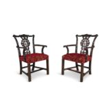 A PAIR OF GEORGE II CARVED MAHOGANY ELBOW CHAIRS, in the Chippendale taste, the crest rail with