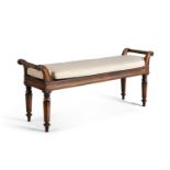 A GEORGE IV MAHOGANY FRAMED LONG STOOL, the rectangular panelled seat with loose squab cushion on