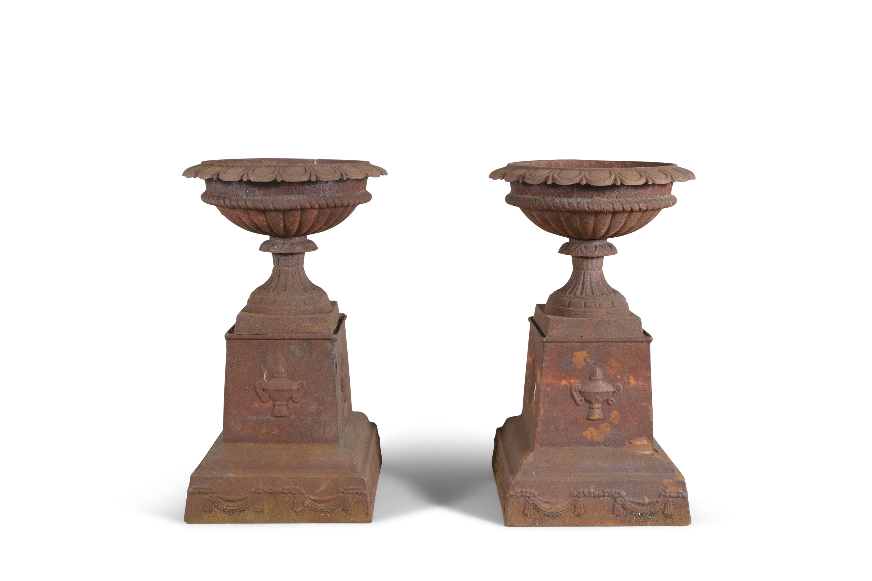 A PAIR OF VICTORIAN CAST IRON GARDEN URNS AND PEDESTALS, of compressed campagna form, with out-