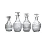 A COLLECTION OF FOUR IRISH CUT GLASS DECANTERS AND STOPPERS, each 'mushroom' stopper with flared