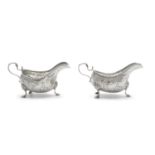 A PAIR OF EDWARDIAN SILVER EMBOSSED SAUCE BOATS, London 1908, mark of Thomas Bradbury & Sons Ltd,