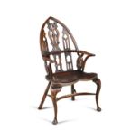A GOTHIC STYLE STAINED WOOD WINDSOR ARMCHAIR, 20th century, with arched panel back, with pierced