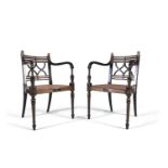 A PAIR OF REGENCY STYLE EBONISED AND PARCEL GILT OPEN ARMCHAIRS, each with interlaced splat back and