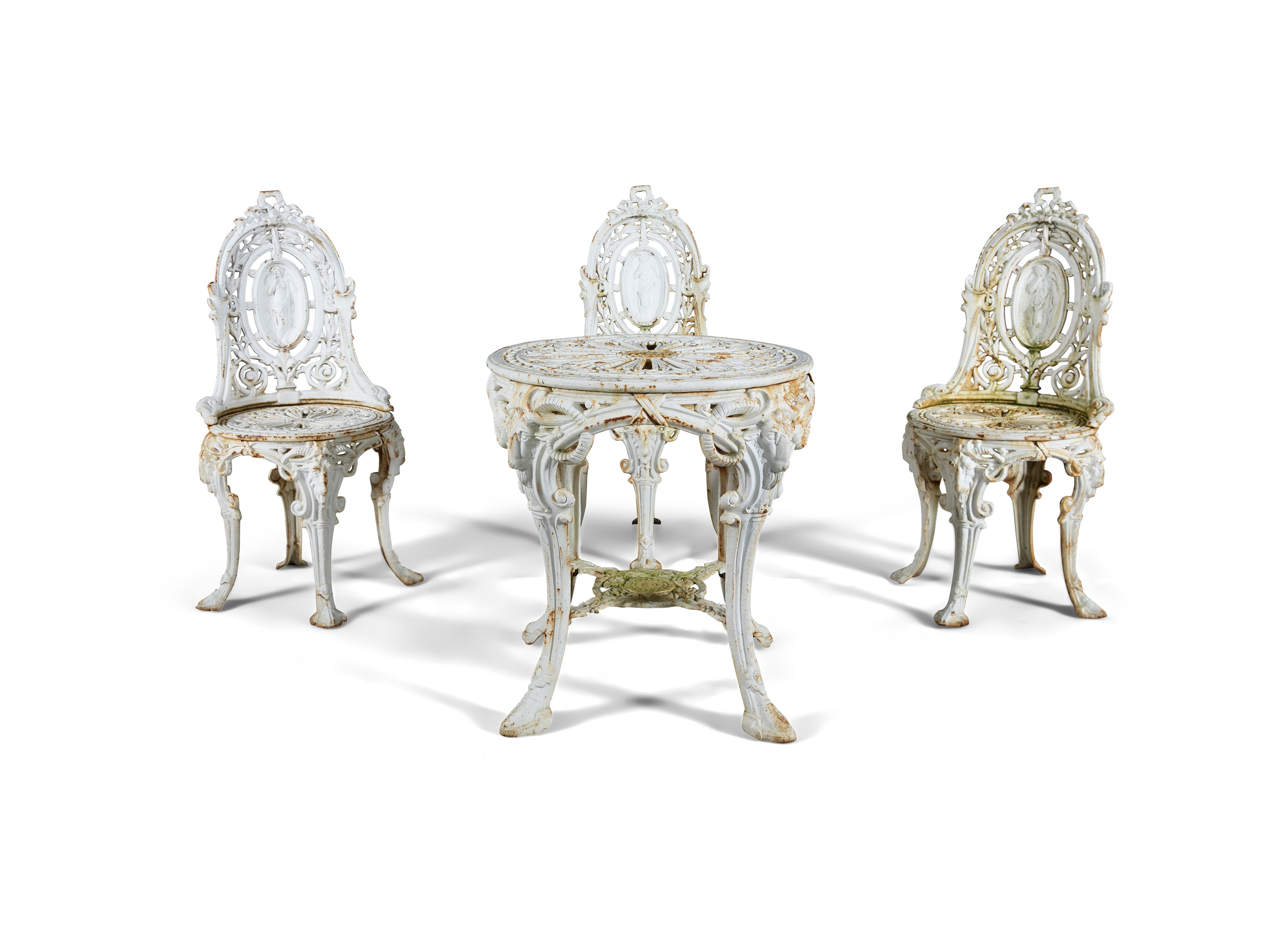 A WHITE PAINTED CAST IRON GARDEN TABLE AND THREE CHAIRS, the table with pierced circular geometric