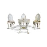 A WHITE PAINTED CAST IRON GARDEN TABLE AND THREE CHAIRS, the table with pierced circular geometric