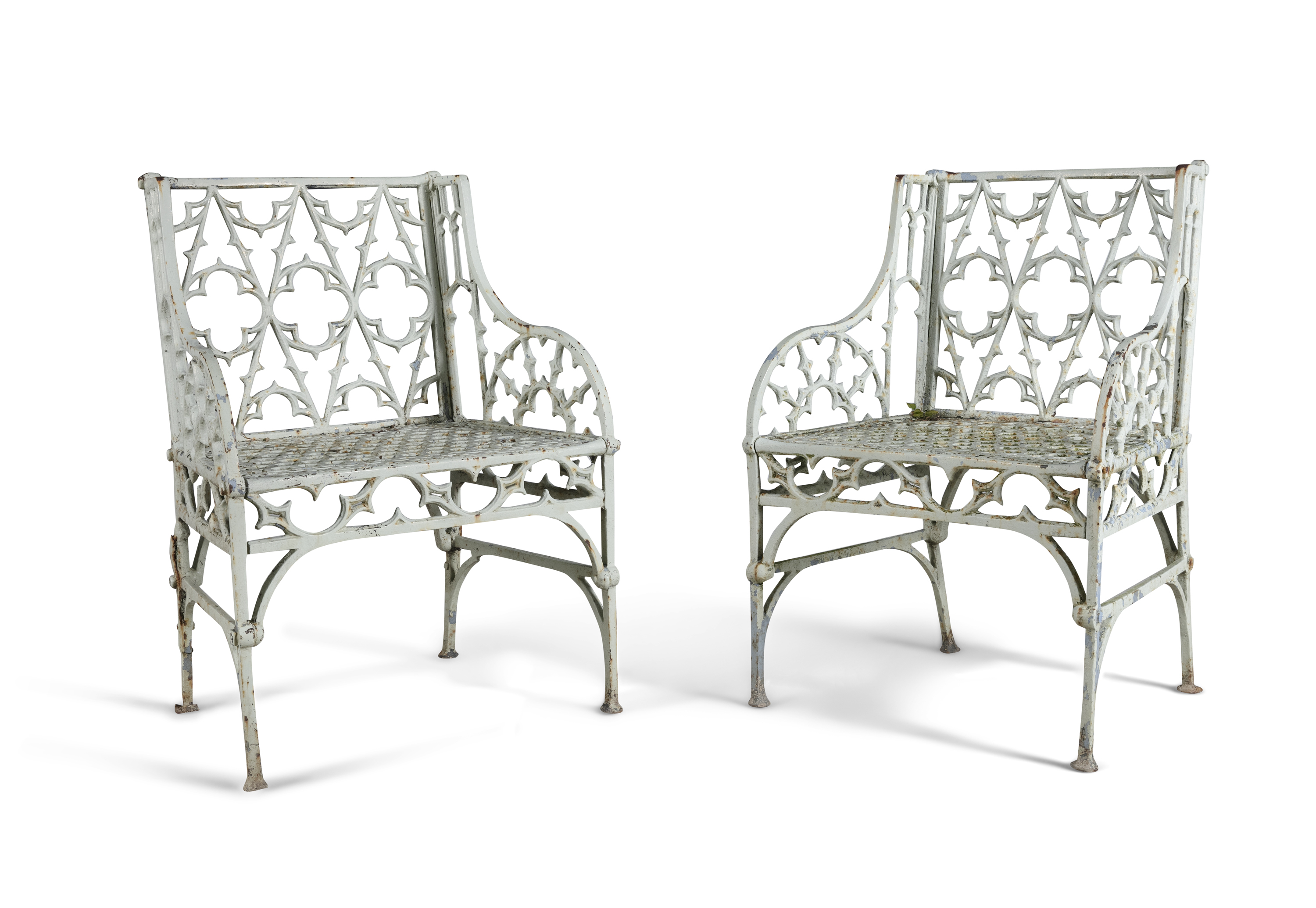 A PAIR OF VICTORIAN GOTHIC PATTERN CAST IRON GARDEN CHAIRS, each pierced with quatrefoils and gothic