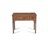 A GEORGE III MAHOGANY LOW BOY, of rectangular form, the moulded top above three frieze drawers,