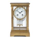 AN EDWARDIAN BRASS CASED UPRIGHT MANTLE CLOCK, of rectangular form, the suspended drum clock with