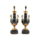 A PAIR OF MARBLE AND GILT METAL MOUNTED TABLE LAMPS, in the French empire style, applied with swan