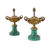 A PAIR OF GILDED BRONZE LAMPS, in the form of Bacchic urns, on simulated malachite bases (