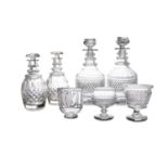 A PAIR OF IRISH EARLY 19TH CENTURY CUT GLASS MALLET SHAPED DECANTERS, each 27cm high; a pair of