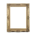A 19TH CENTURY GILTWOOD PICTURE FRAME, each corner and the middle of each side decorated with rococo