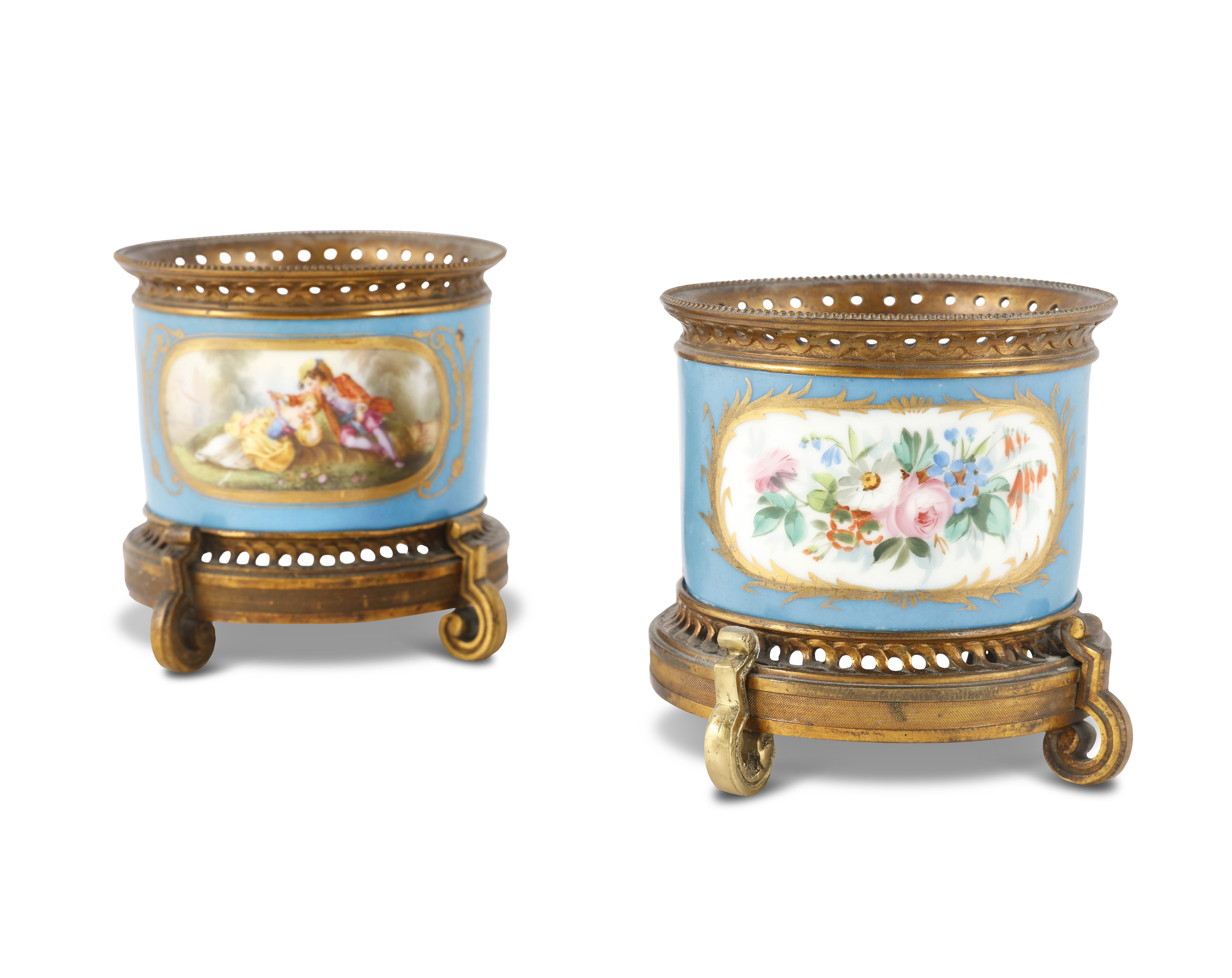 A PAIR OF SEVRES STYLE PORCELAIN CACHE POTS, with ormolu mounts, the cylindrical bodies painted with