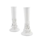 A pair of Woestynroos Porcelain Collection spill vases of tapering cylindrical form, on a leaf