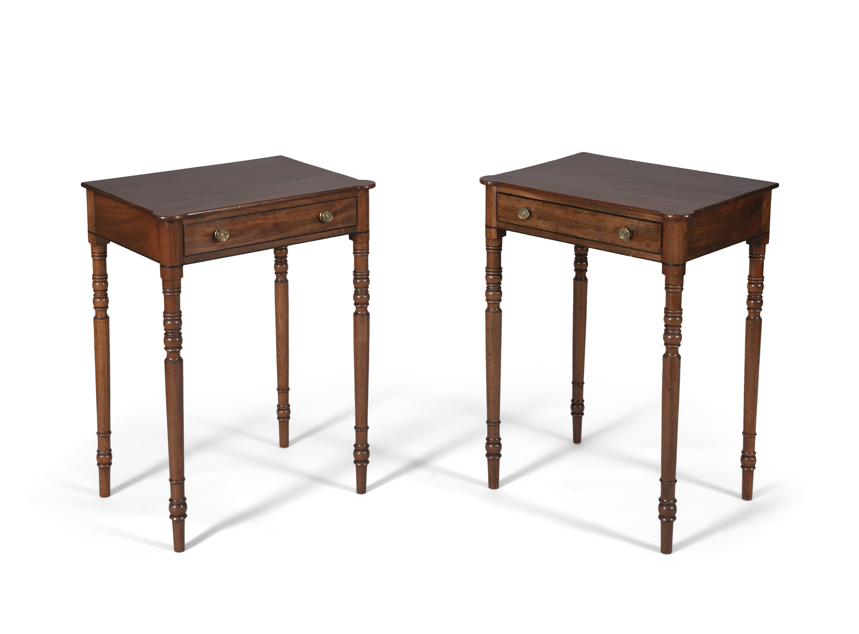 A pair of Regency mahogany rectangular side tables, the plain tops with rounded front angles above a