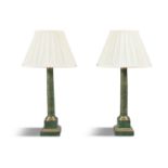 A pair of brass mounted green marbleised column table lamps, of plain circular form, raised on