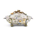 An 18th century French faience shaped oval tureen, Marseille, the lid with twig and fruit handle,