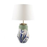 A polychrome Liberty style pottery baluster vase, adapted as a table lamp, the off-white ground