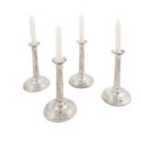 A set of four silver table candlesticks, London 1998, of plain circular form, raised on spreading