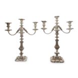 A pair of Sheffield plated candelabra, with detachable three light sconces, raised on foliate cast