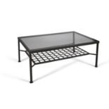 A wrought iron rectangular coffee table, the plate glass top raised above a lattice lower tier, on