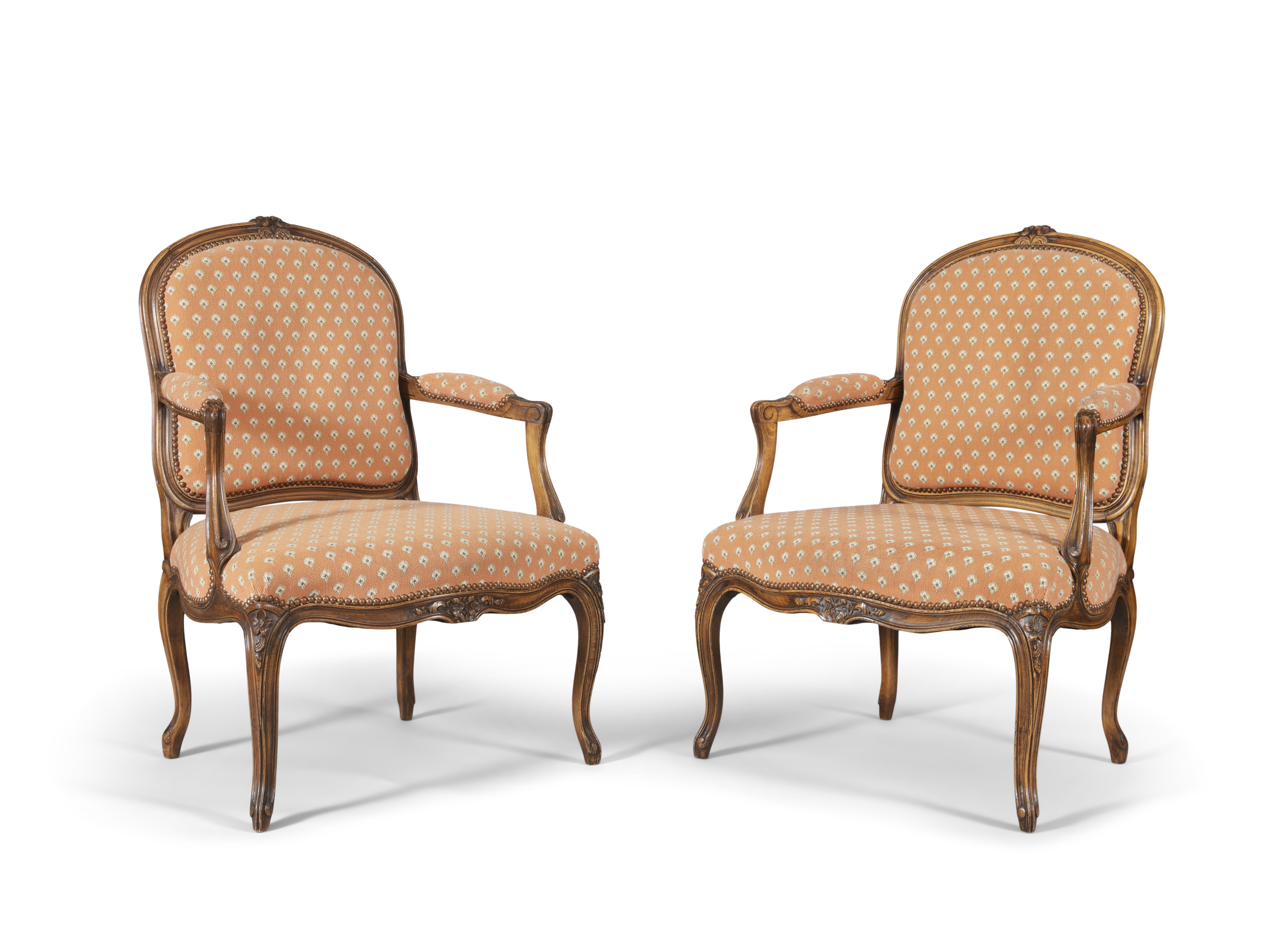 A pair of Louis Quinze style stained beech framed fauteuils, the moulded frame surmounted with