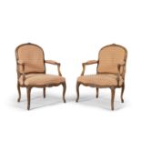 A pair of Louis Quinze style stained beech framed fauteuils, the moulded frame surmounted with