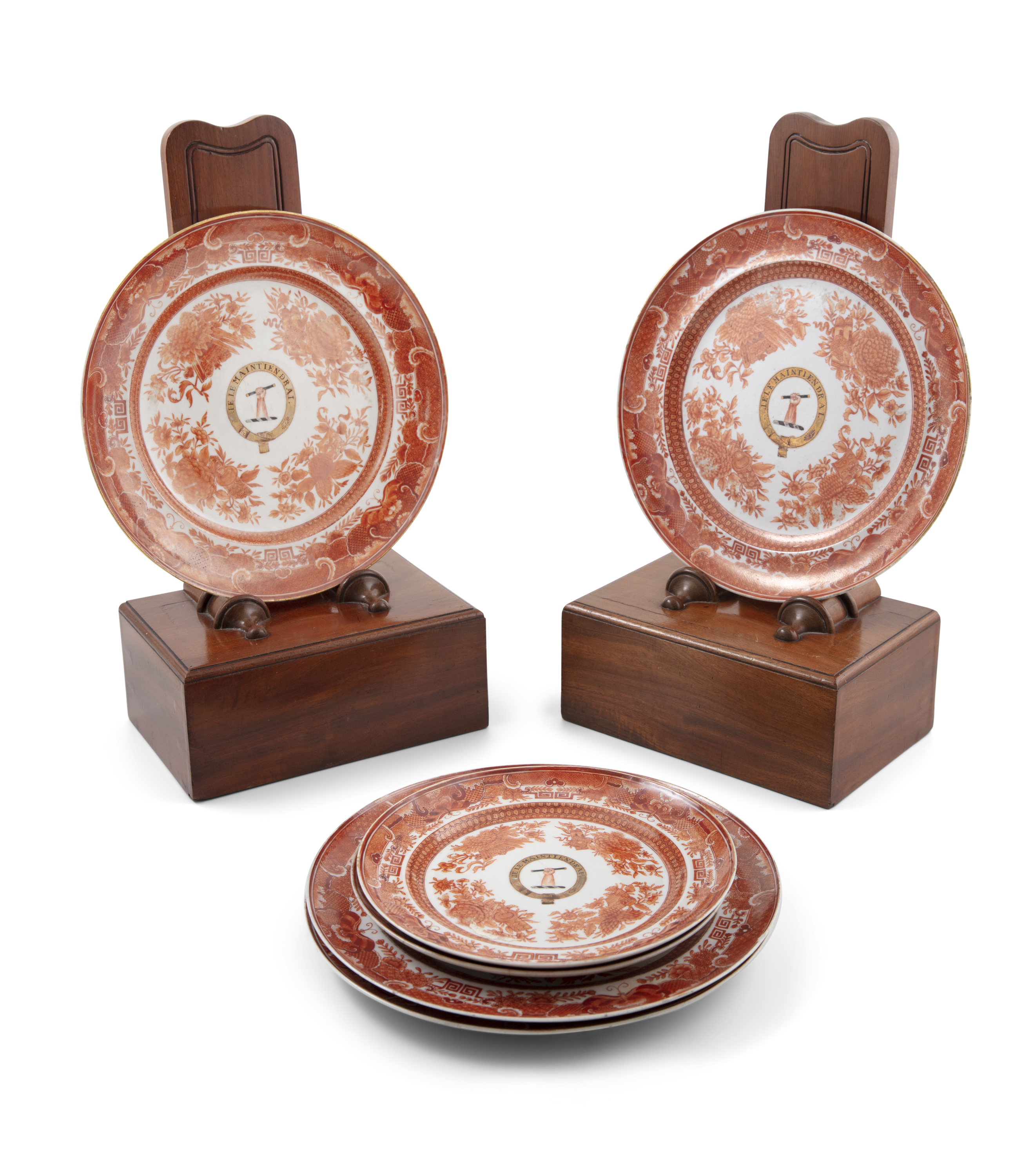 A set of six Chinese export porcelain plates with floral and geometric patterns in burnt orange,