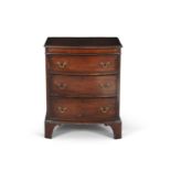 A George III style mahogany compact bowfront chest, of three graduated cockbeaded drawers with brass