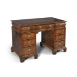 An early Georgian style walnut veneered twin pedestal desk, attributed to Restall, Brown & Clennell,