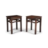 A pair of Chinese padoukwood occasional tables, with moulded rectangular tops raised on square