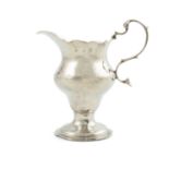 A small Georgian silver cream jug, London 1780, of circular baluster helmet form, on rim foot.