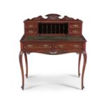 A FRENCH STYLE MAHOGANY WRITING TABLE, the superstructure with carved cresting, fitted with