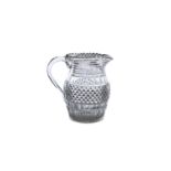 AN IRISH REGENCY CUT GLASS WATER PITCHER, with serrated rim over bands of slices and a broad section