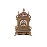 A SMALL GILT METAL AND PORCELAIN INSET MANTLE CLOCK. 27cm high