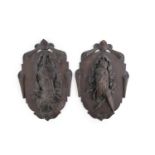 A PAIR OF BLACK FOREST CARVED LINEN WOOD WALL PLAQUES, 19th century, each formed as shield shape