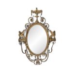 A FINE GILTWOOD AND GESSO ADAMS REVIVAL WALL MIRROR, 19th century, with oval bevelled glass plate,