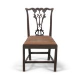 AN EARLY 19TH CENTURY MAHOGANY DINING CHAIR, in the Chippendale taste, with leaf carved and
