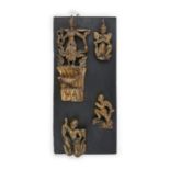 AN ORIENTAL EBONISED AND GILTWOOD PANEL, of upright rectangular form, mounted with Burmese deities