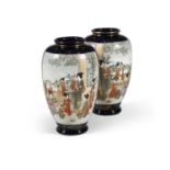 A PAIR OF JAPANESE POTTERY VASES, the deep blue and gilt ground decorated with two panels each of