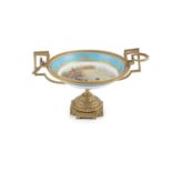 A SEVRES PORCELAIN AND ORMOLU MOUNTED TAZZA, of circular form, with beaded rim and twin handles, the