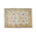 A SEMI-ANTIQUE WOOL CARPET, the central field filled with arabesque scrolls and palmettes in
