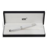 A FOUNTAIN PEN BY MONTBLANC, white coloured with steel engravings 'Meisterstuck Pix Montblanc'