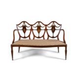 AN EDWARDIAN PAINTED SATINWOOD TRIPLE CHAIR BACK SETTEE, c.1900, the pierced back painted with